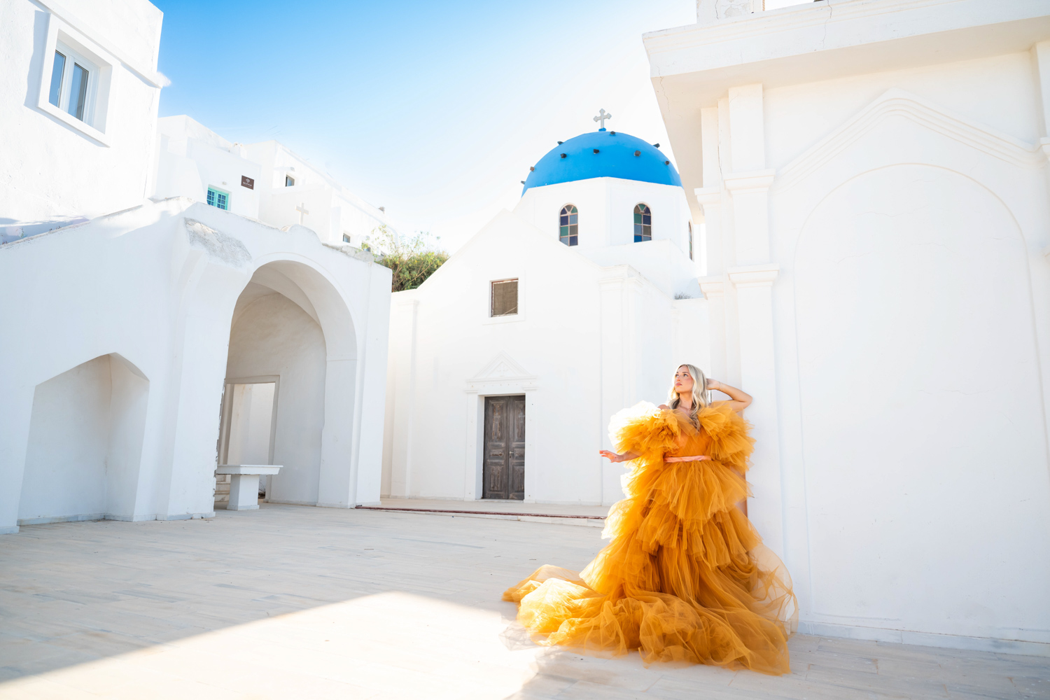 Creative portrait photoshoot by the Santorini blue domes