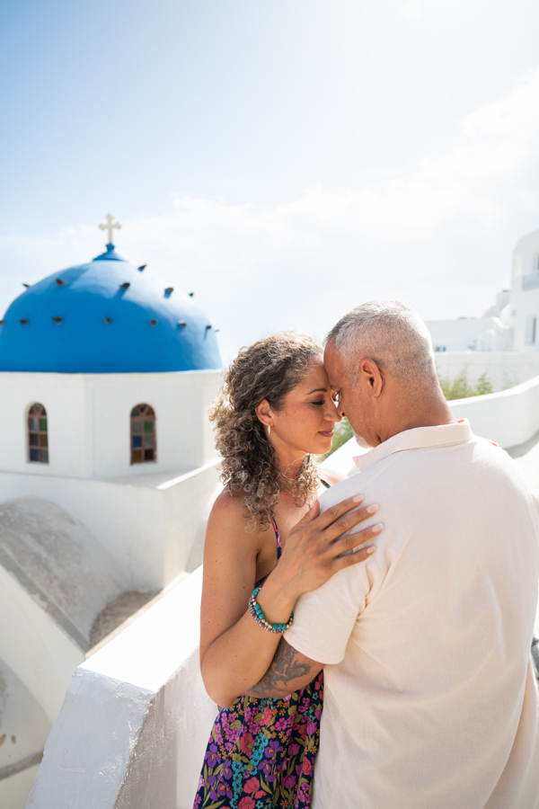 Couple photoshoot near a blue-domed church in Santorini