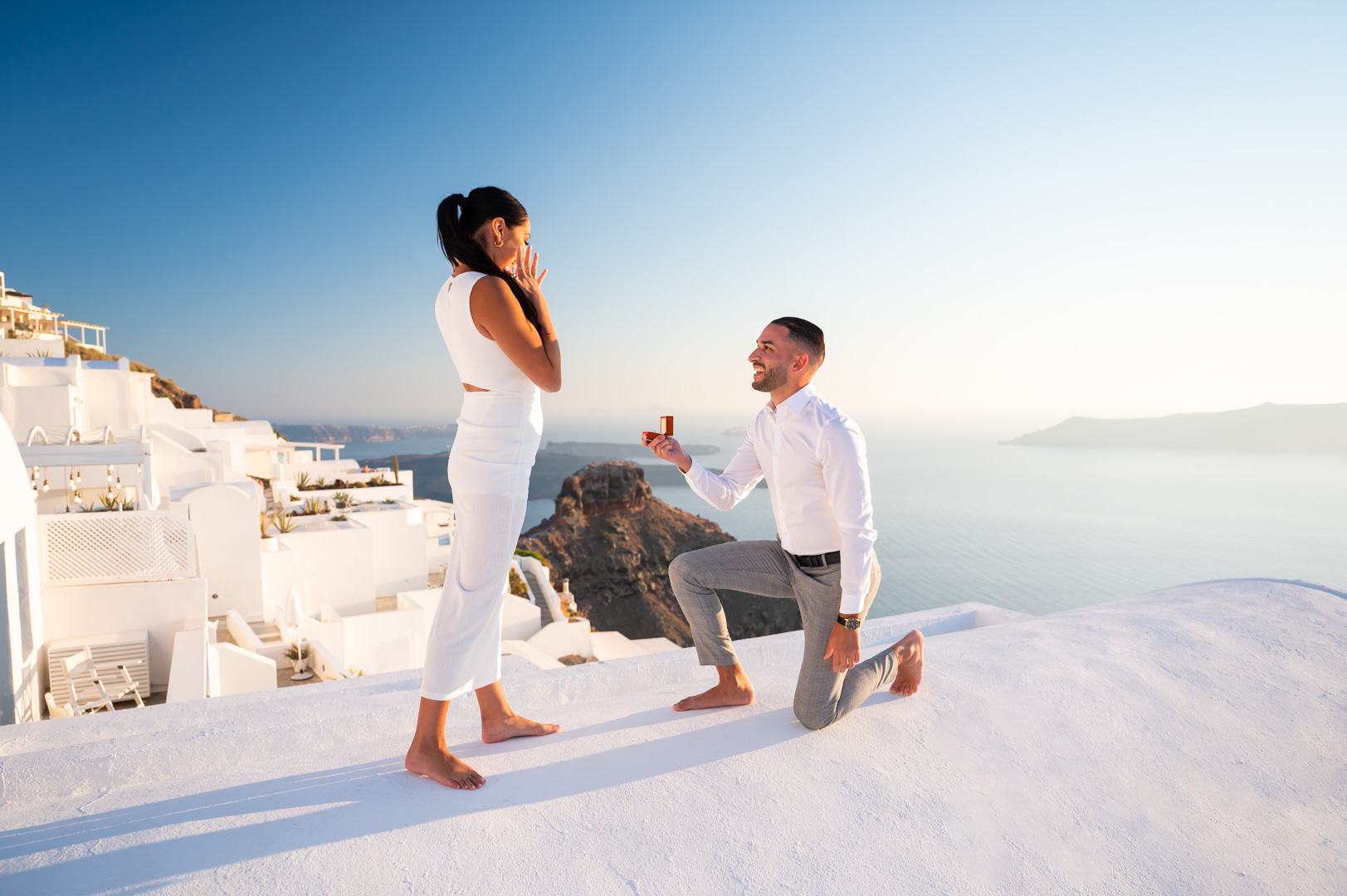 Couple celebrating a proposal during a Santorini photoshoot