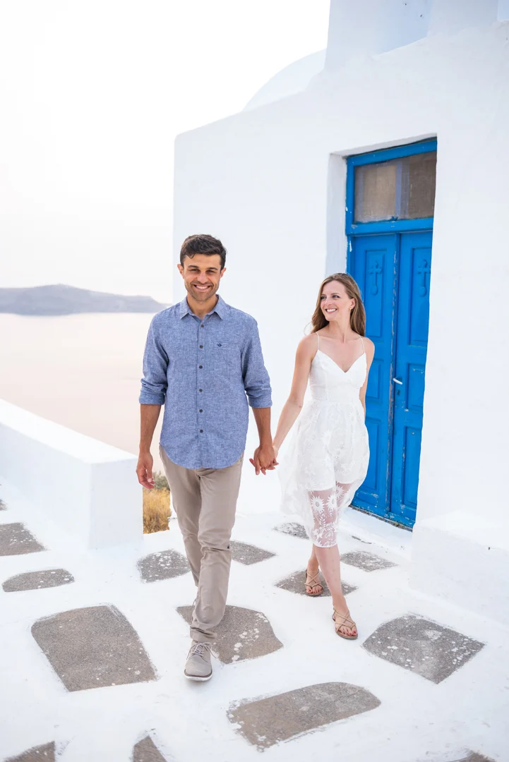 Couple photoshoot in Santorini by a traditional blue door