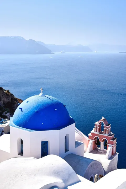 Oia photoshoot location with a blue-domed church and caldera view
