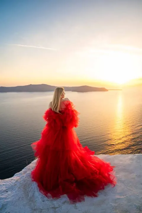 Flying dress outfit photoshoot in Santorini at sunset